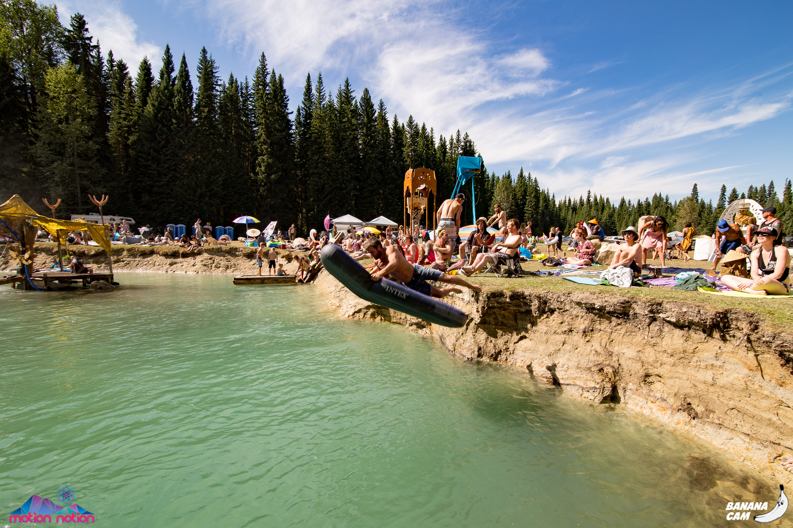 motion notion festival raver diving into lake on a raft