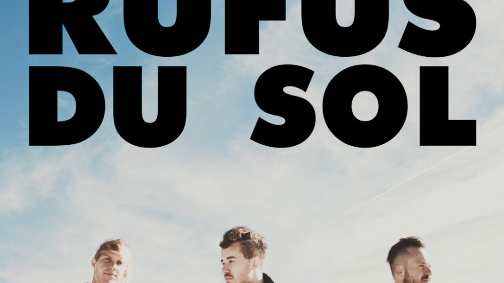 RUFUS DU SOL trio members stand below their group logo.