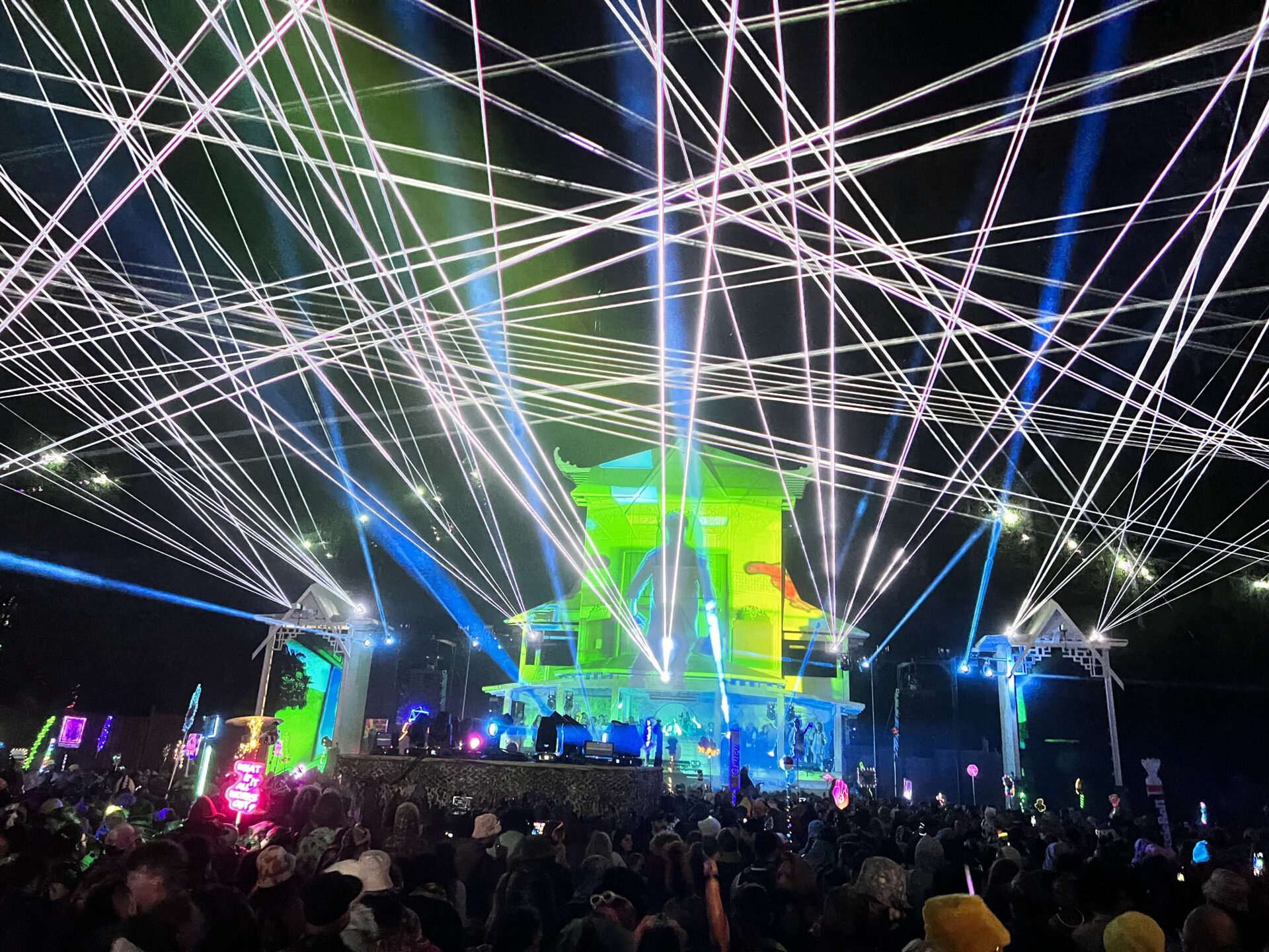 Pagoda at night with blue and green lasers