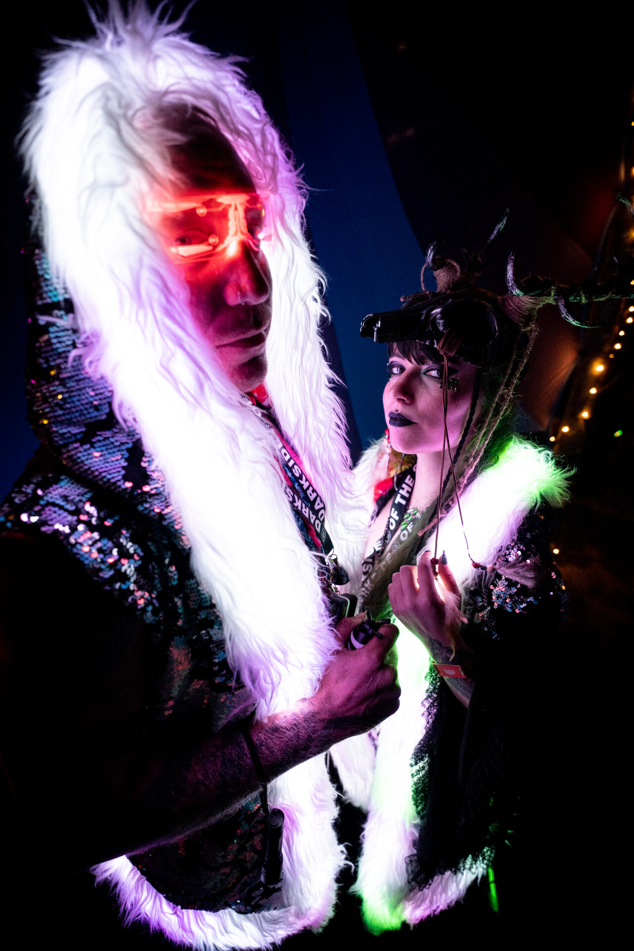 Man and woman wearing fluorescent fur hoods