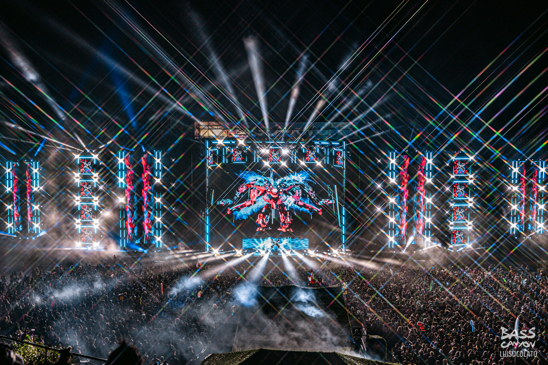 photo of main stage visuals at night with Excision robot on screen with lasers and crowd, Bass Canyon 2024