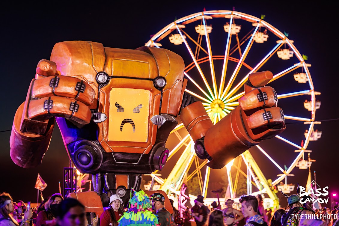 photo of Excision Home Robot with frowny face and ferris wheel in background Bass Canyon 2024